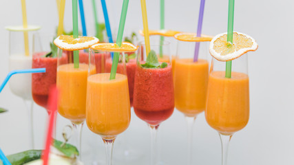 Close-up of cocktail with tropical fruit in wineglass. Fresh exotic juice like a concept of summer, travel