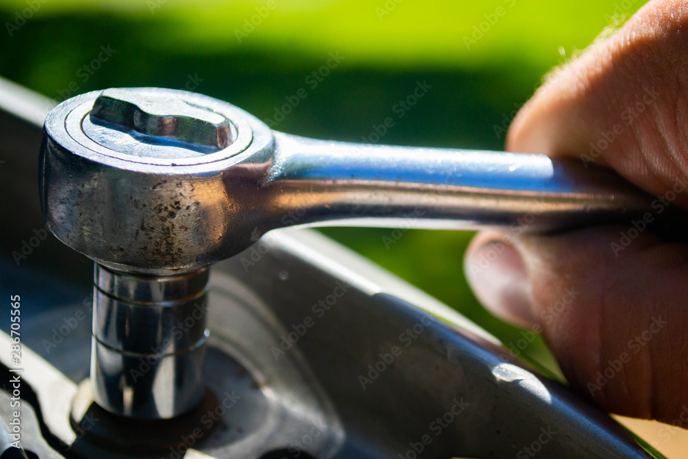 Wall mural a mechanic performing auto repair with a socket wrench