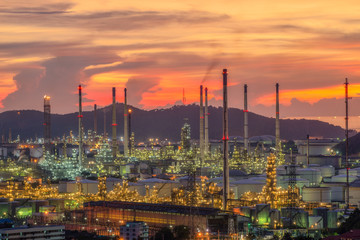 oil​ refinery​ and​ petrochemical​ plant​ industry, refinery​ factory, natural​ gas​ storage​ tank, silhouette​ petroleum​ industrial​ at​ yellow​ sunrise​ sky​ background​