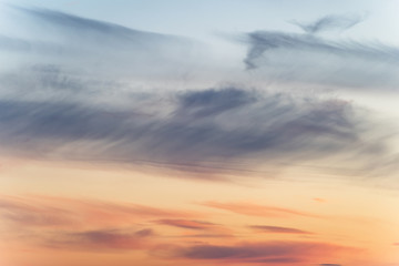 sunset background. sky with soft and blur pastel colored clouds. sunshine through the gradient cloud on the beach resort. nature. sunrise.  peaceful morning