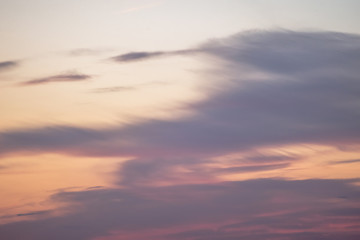 sunset background. sky with soft and blur pastel colored clouds. sunshine through the gradient cloud on the beach resort. nature. sunrise.  peaceful morning