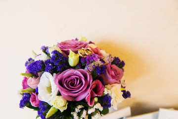 Wedding accessories bride and groom. Wedding bouquet, groom’s boutonniere, rings, floristry and decorations