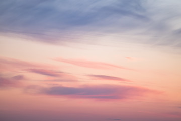 Naklejka na ściany i meble sunset background. sky with soft and blur pastel colored clouds. sunshine through the gradient cloud on the beach resort. nature. sunrise. peaceful morning