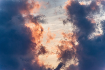 Fototapeta premium sunset background. sky with soft and blur pastel colored clouds. sunshine through the gradient cloud on the beach resort. nature. sunrise. peaceful morning