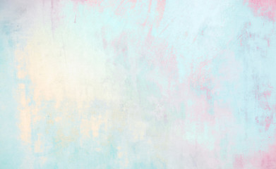 Beautiful abstract wall texture with decorative plaster in grunge style with mixed shades of light blue, pink and golden. Gentle soft background Wallpaper in pastel colors, copy space.