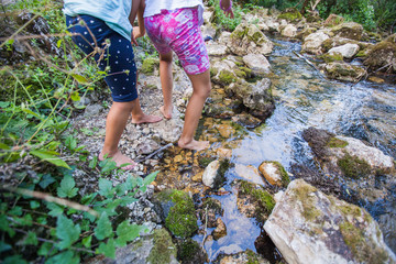 Children adventure at forest creek in nature