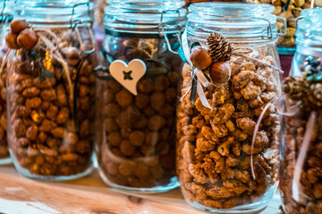 Different types of nuts and seeds in glass jar close up. A variety of nuts in glass jars.