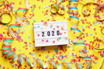 2020 new year celebration flat lay concept with confetti and streamers