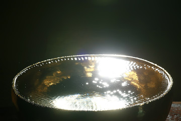 clear water in a golden bowl / clear water in a yellow iron bowl