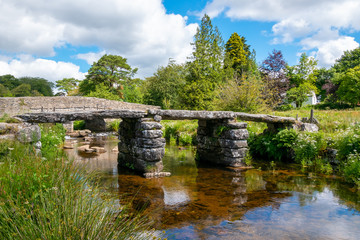 Fototapeta na wymiar Ancient clapper bridge in Postbridge, Dartmoor National Park, Devon, England