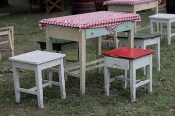 Village table with checkered tablecloth and chairs 02