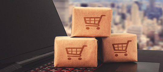 Online shopping / ecommerce and delivery service concept : Paper cartons with a shopping cart or...