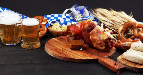 Traditional German cuisine, Schweinshaxe roasted ham hock. Beer, pretzels and various Bavarian specialties. Oktoberfest background