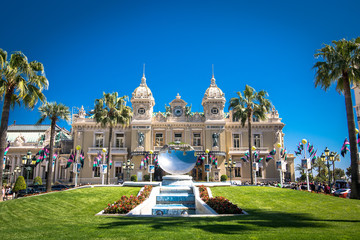 Photo taken from front to Casino Monte Carlo. Several tourists and a beautiful blue sky day....