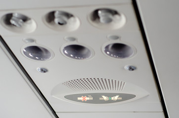 Individual lighting and fans are mounted in panel above passenger seats in cabin.
