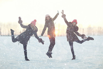 group of girls winter nature fun jump
