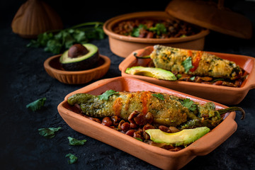 Mexican Chiles Rellenos Served on Traditional Clay Dishes