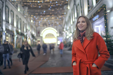 winter night in the city lights / adult girl in a coat walk in the city, fashionable stylish image of a beautiful model