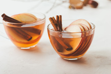 Autumn hot spicy tea glasses with cinnamon sticks