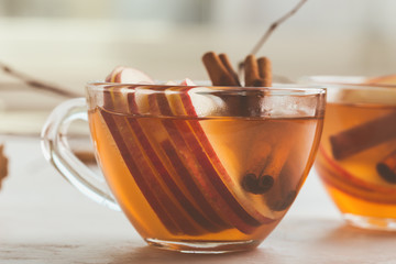 Autumn hot spicy tea glasses with cinnamon sticks