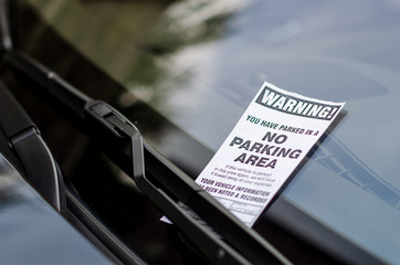 Close-up of parking ticket on car's windshield