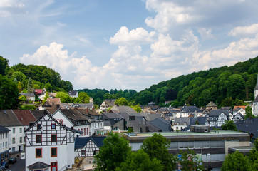 Fototapeta na wymiar View of buildings and church in Blankenheim fron near hills
