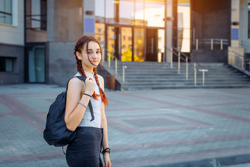 Portrait of University student, girl with backpack while going to college from street, teenager in campus. Education concept.