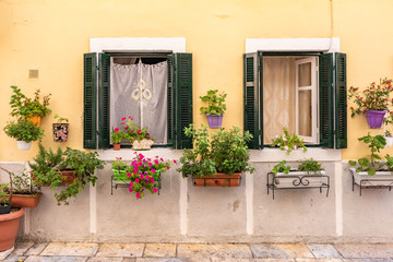 Fototapeta na wymiar Decorated windows on the streets of Greece