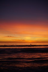 VIBRANT SUNSET WITH SURFERS SPORTS
