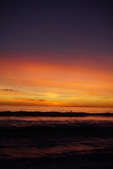 VIBRANT SUNSET WITH SURFERS SPORTS