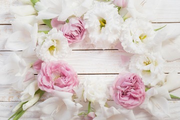 Fototapeta na wymiar pink and white flowers on white wooden background