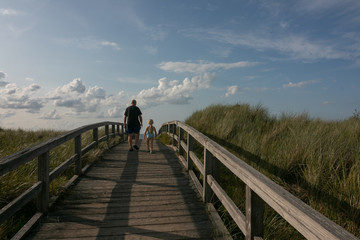 grandfather with grandson daughter on a baordwalk