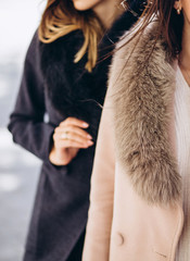 girl in a winter coat with a fur collar outdoors. Fashionable and trendy clothes. Autumn style. spring autumn collection. women's clothing business style office wear casual. Young sexy woman.