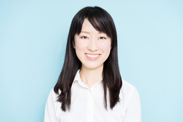 Happy business woman against light blue background