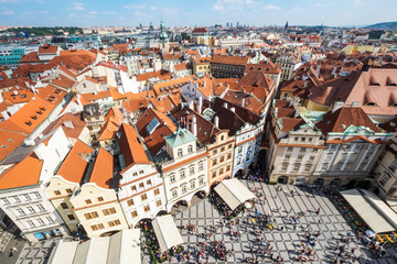 Fototapeta na wymiar Old Town of Prague, Czech Republic. View on Tyn Church and Jan Hus Memorial on the square as seen from Old Town City Hall. Blue sunny sky