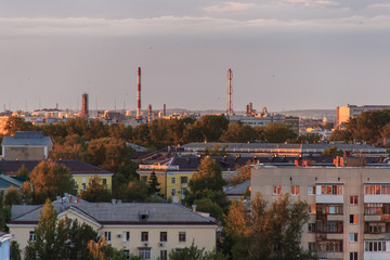 Small soviet city on sunset.The sun comes out from behind the clouds.