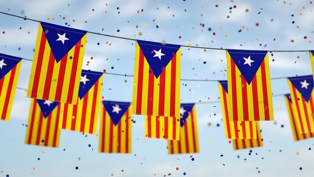 Catalonia flags in the sky with confetti.