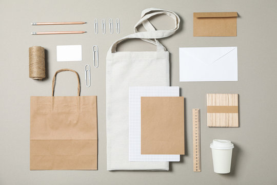 Mockup. Corporate stationery with paper and tote bag on grey background. Flat lay
