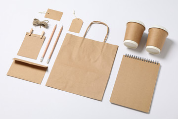 Composition with blank stationery, paper cups and bag on white background, mockup