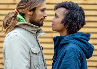 guy with an african american girl in love in autumn park walk at sunset