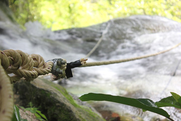 Rope tied to a tree to use to climb the waterfall​ for​ safety.