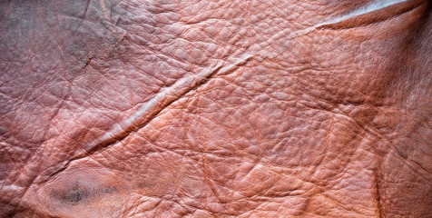 Brown leather texture closeup for background