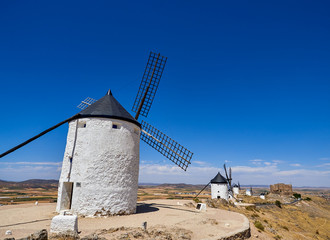 Old windmills and castle in the town of Consuegra, Spain