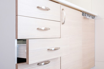 a wooden wardrobe drawer front, metal handle