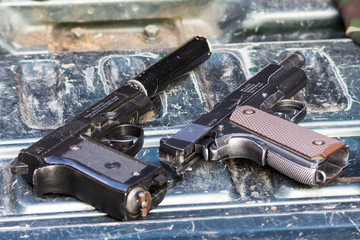 two pneumatic pistols in the car
