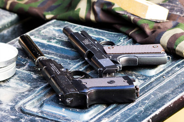 two pneumatic pistols in the car
