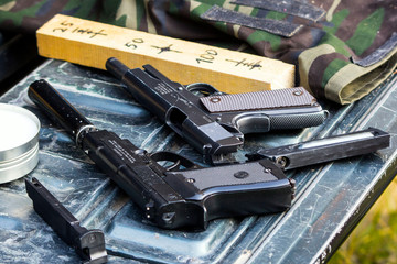 two pneumatic pistols in the car