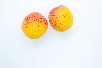 Delicious juicy apricots are located on a white background