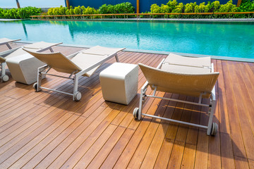chair around swimming pool in hotel resort