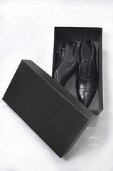 Black plain design executive shoes in its open box